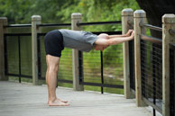 photo of man wearing yoga shorts and doing table pose